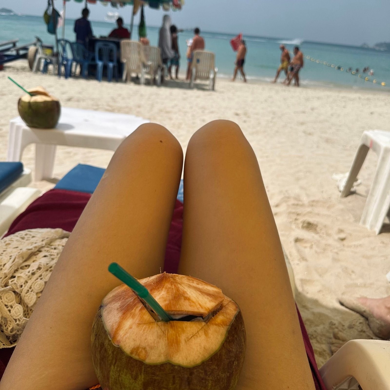 Fresh coconut drink on a sandy beach in Phuket, Thailand
